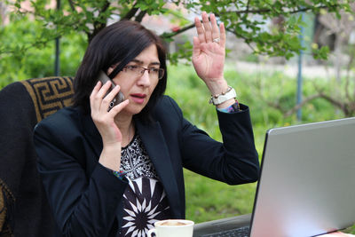 Full length of a young woman using mobile phone