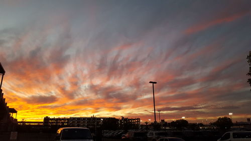 View of dramatic sky over city during sunset