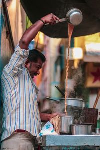Midsection of man preparing food at market