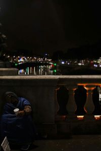 People in illuminated city at night