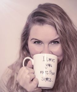 Portrait of young woman drinking coffee cup