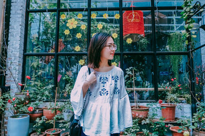 Woman standing against window