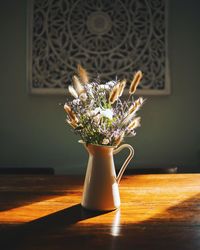 Close-up of flower vase on table at home