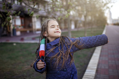 Portrait of girl standing outdoors