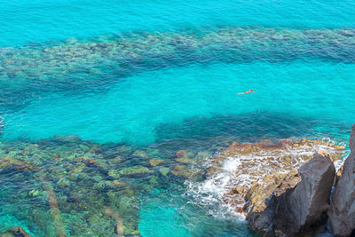 High angle view of man swimming in sea