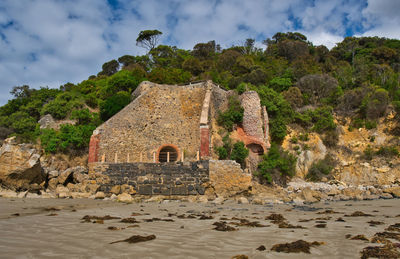 Old ruins by building against sky