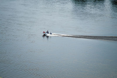 Mid distant view of people in motorboat at lake