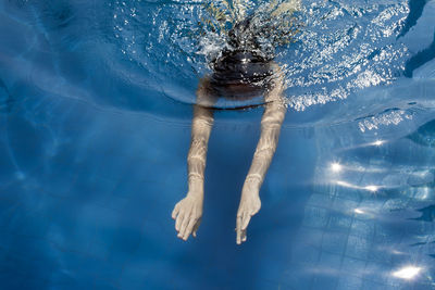 Person swimming in pool