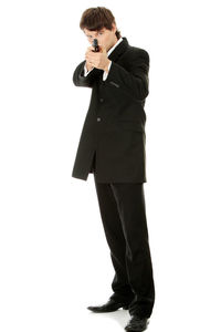 Young man standing against white background