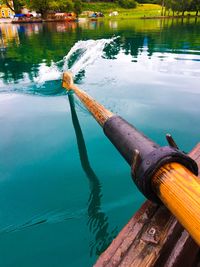 Reflection of man on boat in water