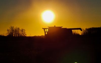 Silhouette built structure against sky during sunset