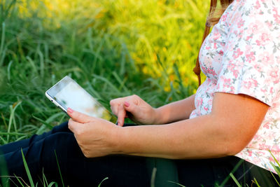 Midsection of woman using mobile phone