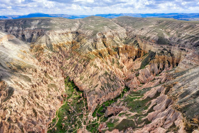 View of landscape with mountain range in background