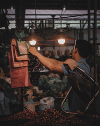 Side view of man working at factory