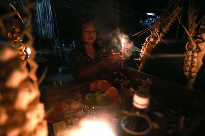 Rear view of woman standing at night