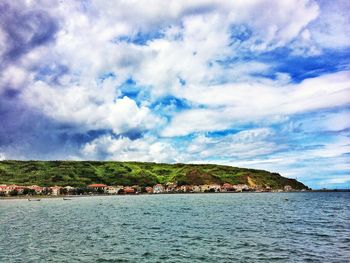 Scenic view of sea against cloudy sky