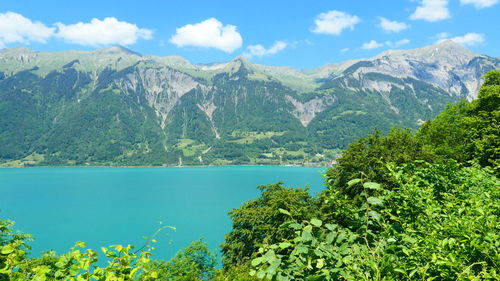 Scenic view of lake and mountains against sky