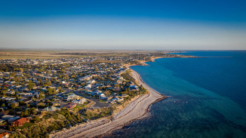 High angle view of sea and cityscape against sky