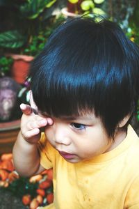 Close-up of cute boy rubbing eye