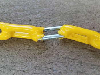 High angle view of yellow toy car on road