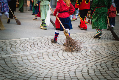 Low section of woman walking on street