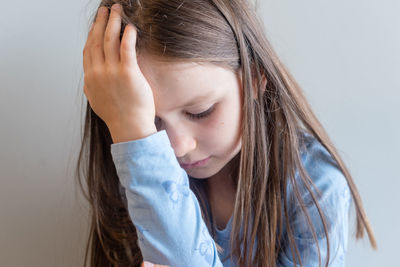 Close-up of girl against white background