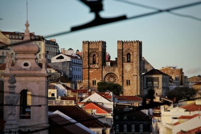 Buildings and lisbon cathedral against sky