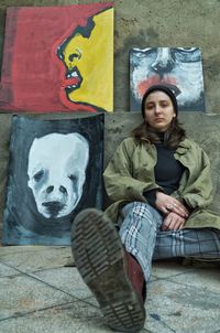 Portrait of young woman sitting outdoors