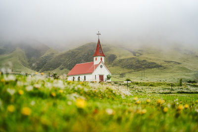Building by mountain against sky