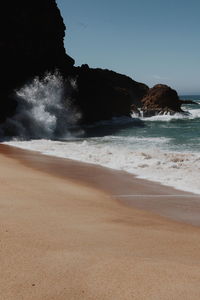 Scenic view of beach against clear sky