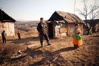 Rear view of people standing outdoors