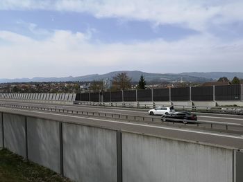 Cars on road against mountain range