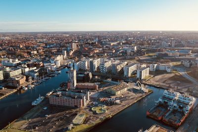 High angle view of river amidst buildings in city against sky