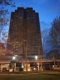 Low angle view of illuminated buildings against sky at night