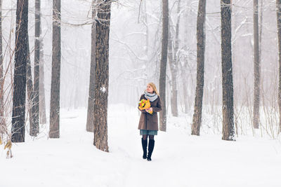 Full length of man standing on snow covered land