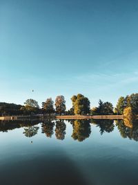 Reflection of trees in lake against sky