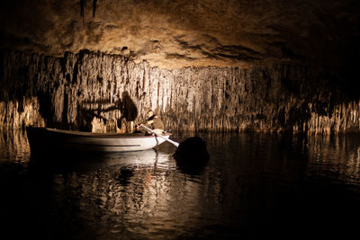 People on boat in cave