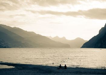 Scenic view of sea and mountains against sky