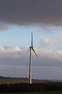 Windmill on field against sky