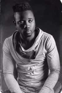 Portrait of young man sitting outdoors