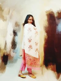 Rear view of smiling girl standing at home