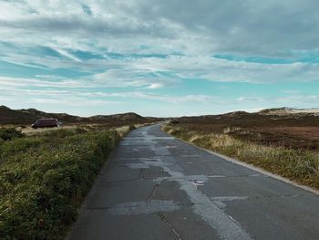 Road amidst landscape against sky