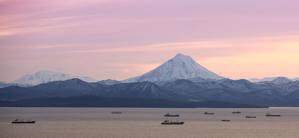 The fishing boats in the bay with the volcano on kamchatka