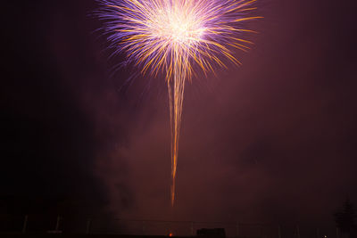 Low angle view of firework display at night