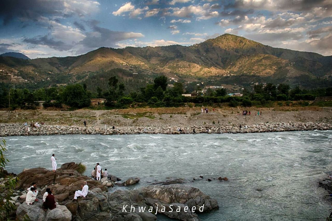 mountain, water, sky, lifestyles, large group of people, leisure activity, men, cloud - sky, mountain range, scenics, person, tourist, beauty in nature, nature, vacations, tranquil scene, lake, medium group of people, high angle view