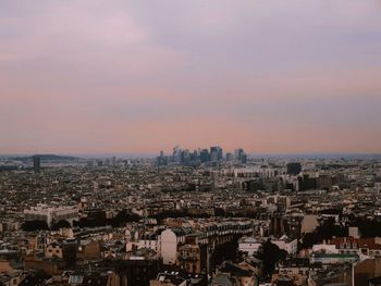 High angle view of city buildings against sky during sunset