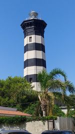 Low angle view of lighthouse against clear blue sky