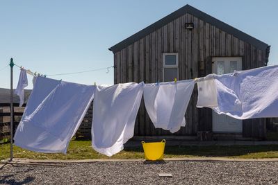 Clothes drying on clothesline outside building