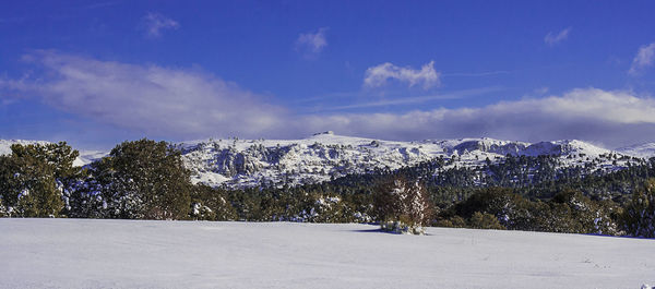 Scenic view of mountains against sky during winter