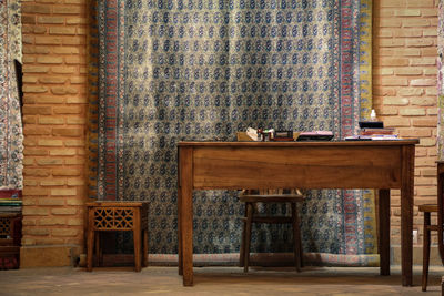 Chairs and table against wall
